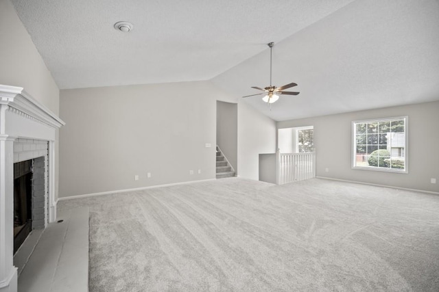 990 Trestle Dr, Austell, GA 30106 - unfurnished living room featuring carpet, a fireplace, a ceiling fan, lofted ceiling, and a textured ceiling