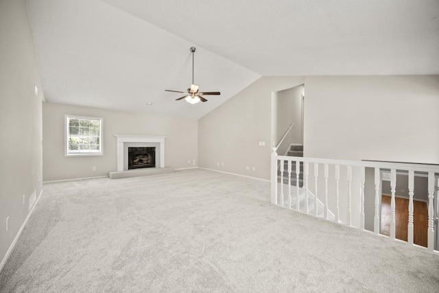 990 Trestle Dr, Austell, GA 30106 - unfurnished living room featuring a ceiling fan, lofted ceiling, carpet, and a fireplace with raised hearth
