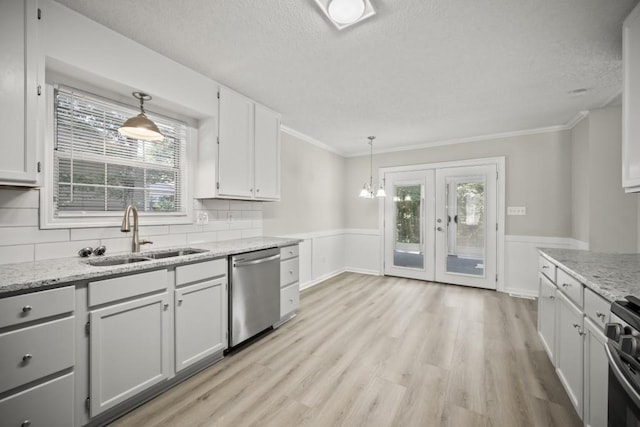 990 Trestle Dr, Austell, GA 30106 - kitchen with appliances with stainless steel finishes, a textured ceiling, a wainscoted wall, light wood-type flooring, and light stone countertops