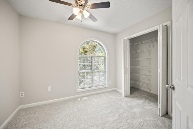990 Trestle Dr, Austell, GA 30106 - unfurnished bedroom with light carpet, a textured ceiling, ceiling fan, and a closet