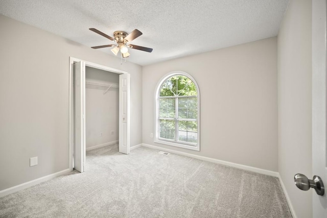 990 Trestle Dr, Austell, GA 30106 - unfurnished bedroom with carpet, a textured ceiling, a closet, and ceiling fan