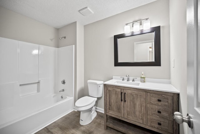 990 Trestle Dr, Austell, GA 30106 - full bathroom featuring wood finished floors, vanity, shower / washtub combination, and a textured ceiling