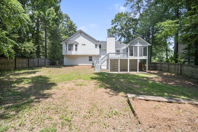 990 Trestle Dr, Austell, GA 30106 - rear view of property with stairs, a sunroom, a fenced backyard, and a chimney