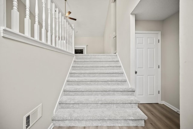 990 Trestle Dr, Austell, GA 30106 - staircase with wood finished floors, a ceiling fan, and a fireplace