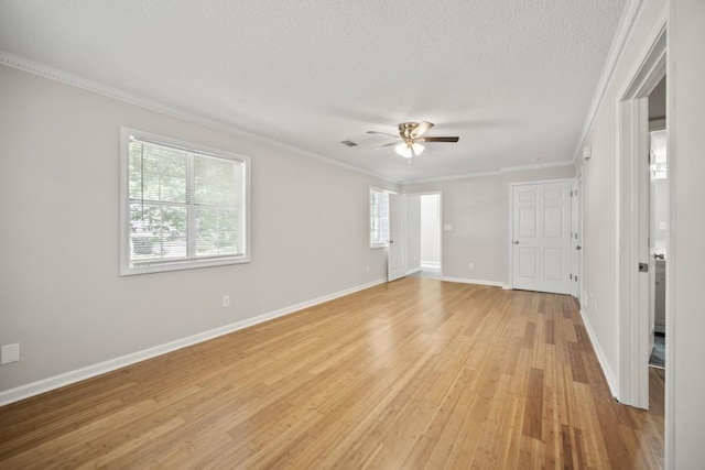 990 Trestle Dr, Austell, GA 30106 - empty room featuring healthy amount of natural light, ceiling fan, light wood-type flooring, crown molding, and a textured ceiling
