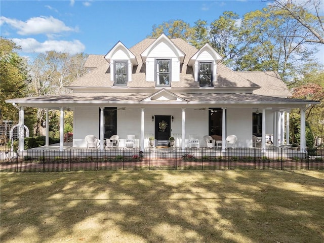 farmhouse-style home with covered porch and a front lawn