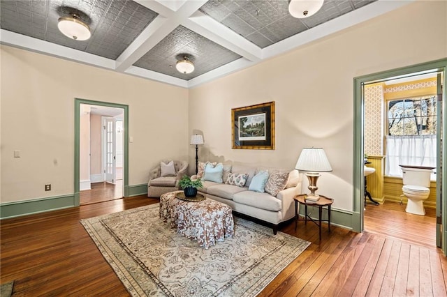 living room featuring coffered ceiling, beam ceiling, and wood-type flooring