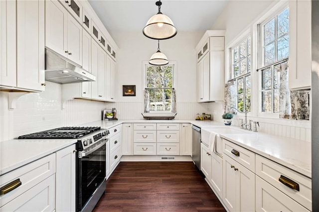 kitchen with sink, white cabinetry, a healthy amount of sunlight, pendant lighting, and stainless steel appliances