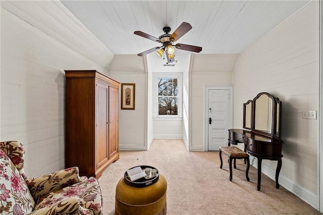 living area with lofted ceiling, light carpet, and ceiling fan