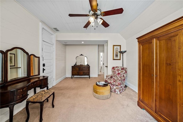 living area featuring lofted ceiling, light colored carpet, and ceiling fan