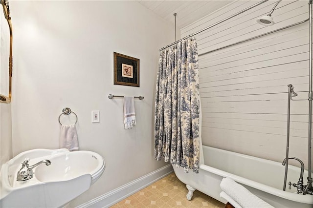 bathroom featuring sink and shower / bathtub combination with curtain