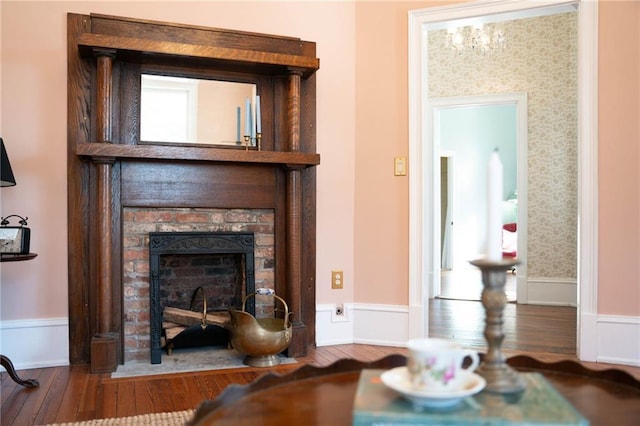 interior space with wood-type flooring and a brick fireplace