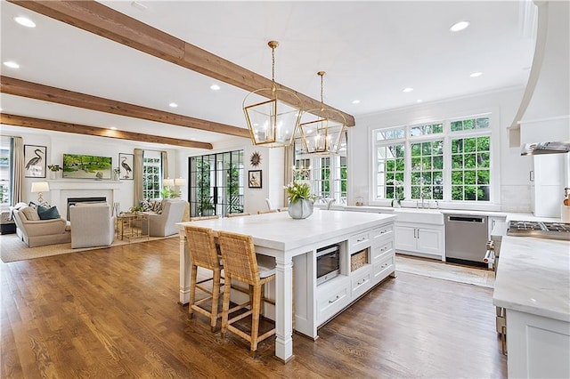 kitchen with a healthy amount of sunlight, appliances with stainless steel finishes, recessed lighting, and white cabinetry