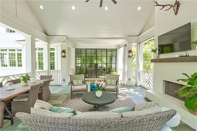 sunroom / solarium featuring plenty of natural light, vaulted ceiling, and recessed lighting