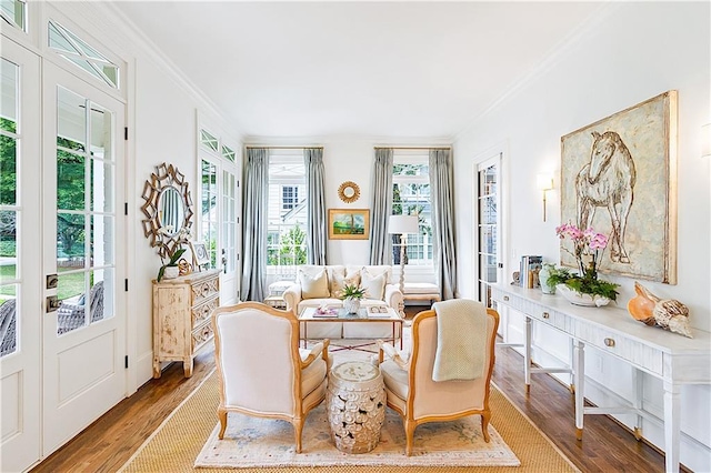 living room with crown molding, french doors, and wood finished floors