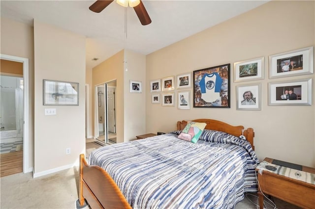 bedroom featuring light colored carpet, ceiling fan, and a closet