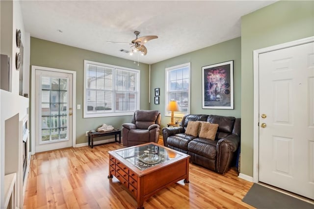 living room with ceiling fan and light hardwood / wood-style floors