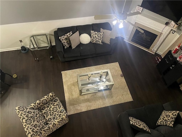living room with a ceiling fan and wood finished floors