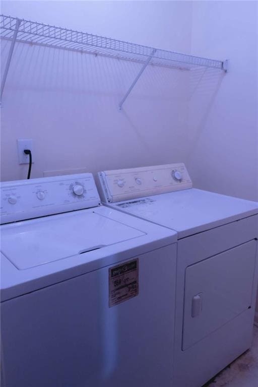 clothes washing area with washer and dryer