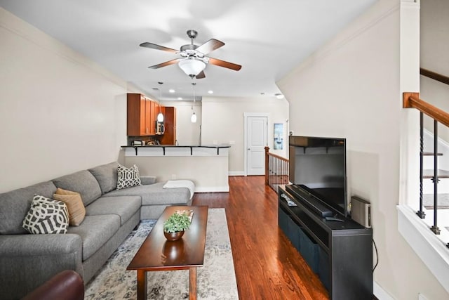 living room with ceiling fan, dark hardwood / wood-style flooring, and crown molding