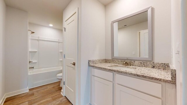142 Post Oak Dr, Jackson, GA 30233 - bathroom with vanity, toilet, wood finished floors, shower / bath combination, and baseboards