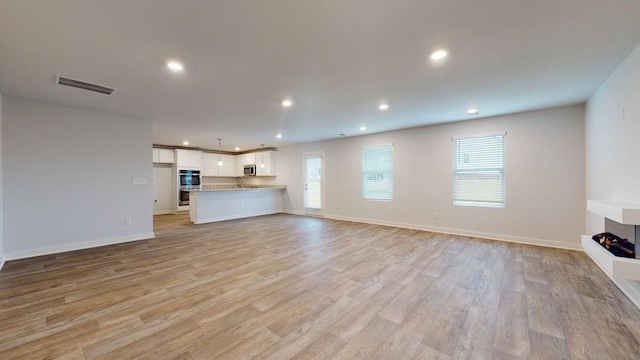 142 Post Oak Dr, Jackson, GA 30233 - unfurnished living room featuring light wood finished floors, recessed lighting, and baseboards