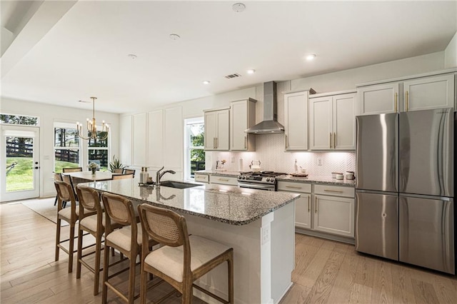 7985 Welch Ml, Ball Ground, GA 30107 - kitchen featuring stainless steel appliances, wall chimney exhaust hood, a sink, light wood-type flooring, and healthy amount of natural light