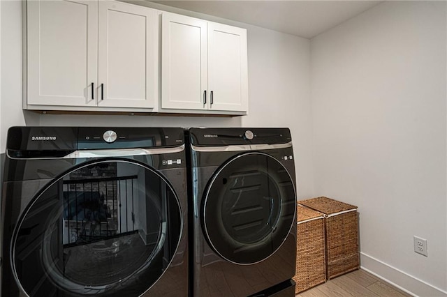 7985 Welch Ml, Ball Ground, GA 30107 - laundry area with cabinet space, washing machine and clothes dryer, baseboards, and light wood-style floors