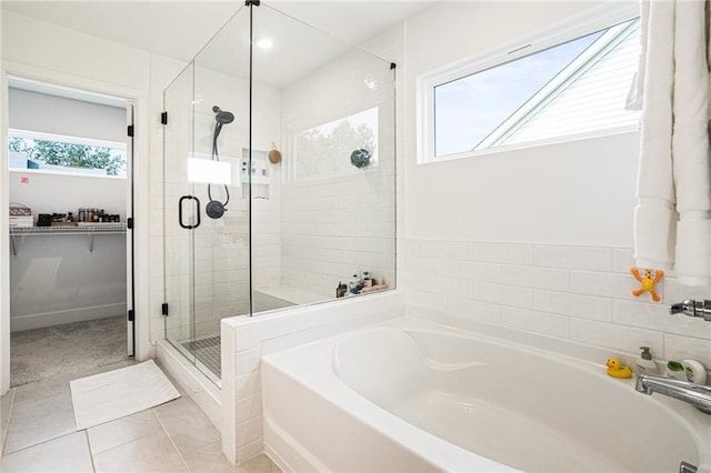 7985 Welch Ml, Ball Ground, GA 30107 - full bathroom with a bath, a stall shower, tile patterned flooring, and a spacious closet