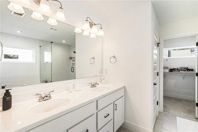 7985 Welch Ml, Ball Ground, GA 30107 - full bath featuring a stall shower, double vanity, a walk in closet, and tile patterned floors