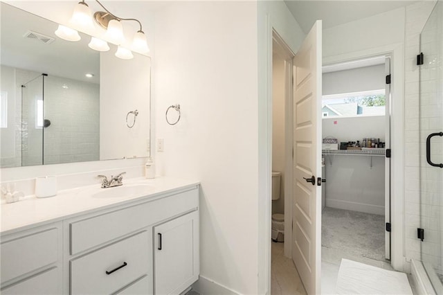 7985 Welch Ml, Ball Ground, GA 30107 - full bathroom with vanity, a stall shower, baseboards, a closet, and toilet