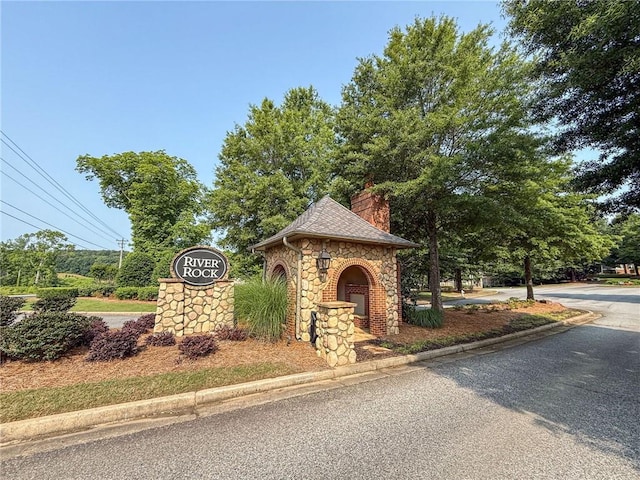 7985 Welch Ml, Ball Ground, GA 30107 - view of front of house with stone siding and a chimney