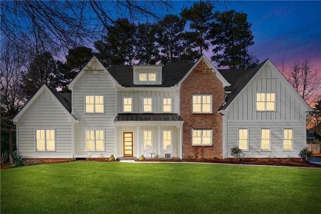 view of front of house featuring a lawn and covered porch