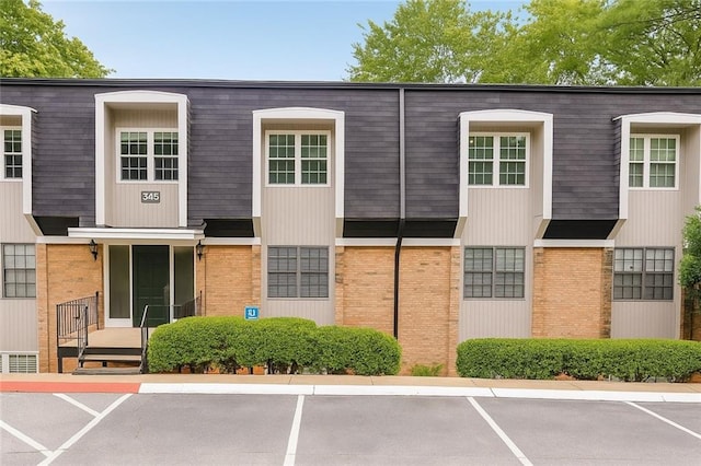 345 Winding River Dr Unit F, Atlanta, GA 30350 - view of property featuring uncovered parking