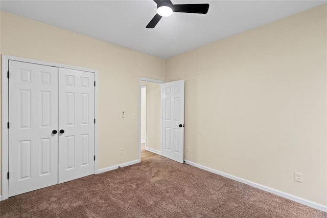 unfurnished bedroom featuring carpet floors, ceiling fan, baseboards, and a closet