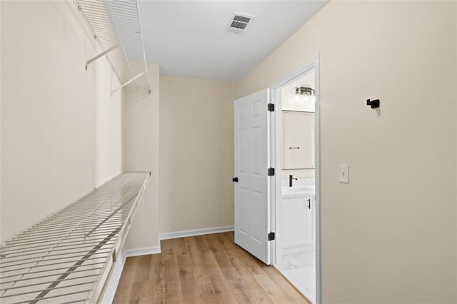 walk in closet featuring visible vents and light wood-style floors