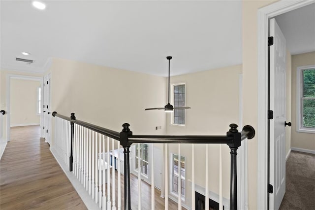 corridor featuring an upstairs landing, recessed lighting, baseboards, and wood finished floors