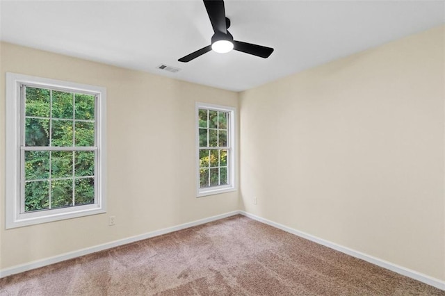 unfurnished room with a ceiling fan, carpet, visible vents, and baseboards