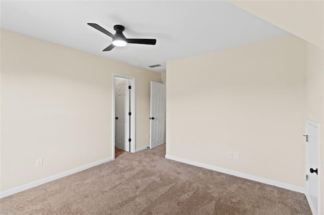 spare room featuring ceiling fan, carpet flooring, visible vents, and baseboards