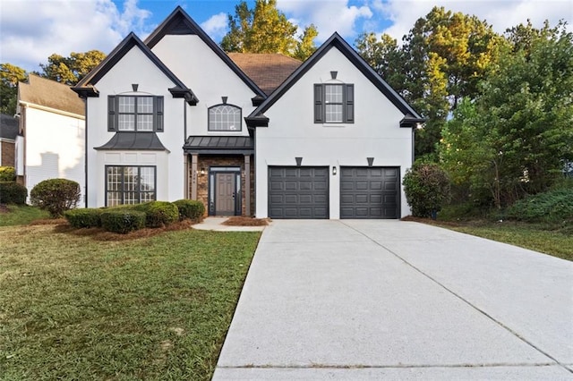 view of front of property featuring concrete driveway, metal roof, an attached garage, a standing seam roof, and a front yard