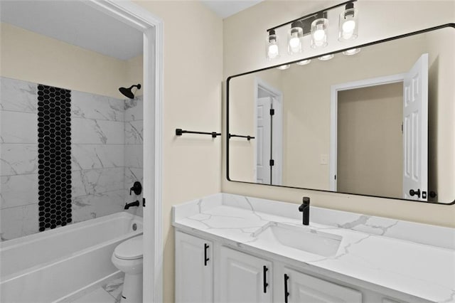 bathroom with marble finish floor, tub / shower combination, vanity, and toilet