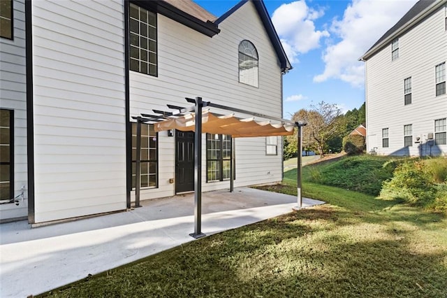 rear view of house with a patio, a yard, and a pergola