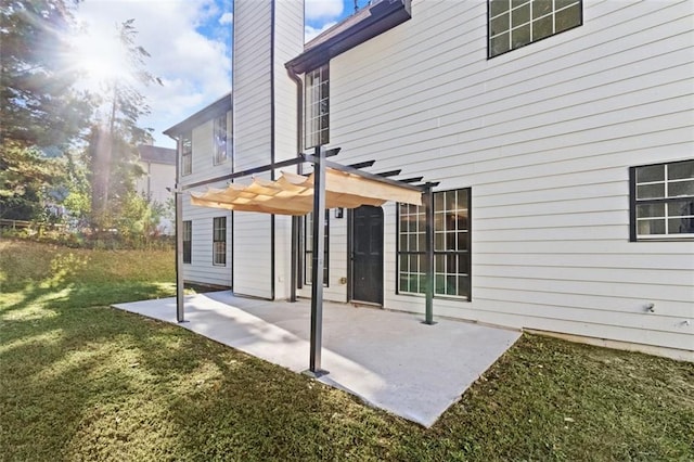 back of property with a patio, a chimney, a lawn, and a pergola