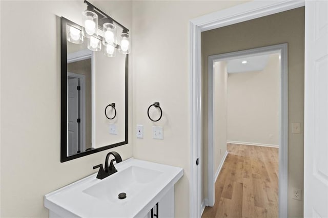 bathroom with vanity, baseboards, and wood finished floors