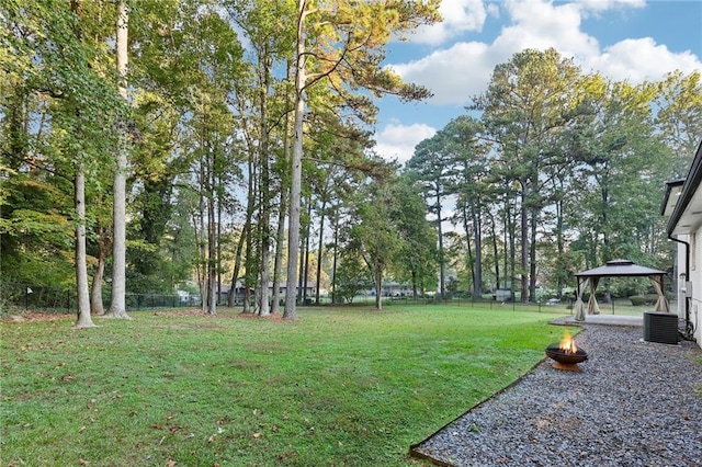 view of yard featuring a gazebo, an outdoor fire pit, and central AC