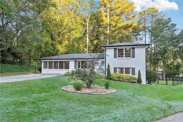 tri-level home with a front yard