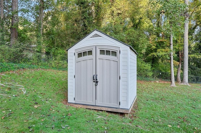 view of outbuilding featuring a yard