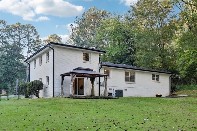 back of house featuring a gazebo and a yard