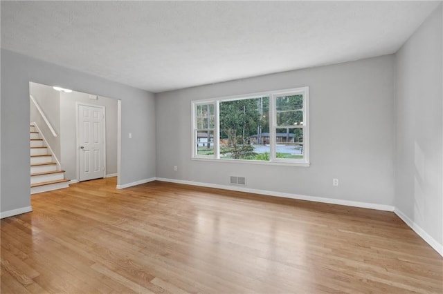 unfurnished room with light wood-type flooring