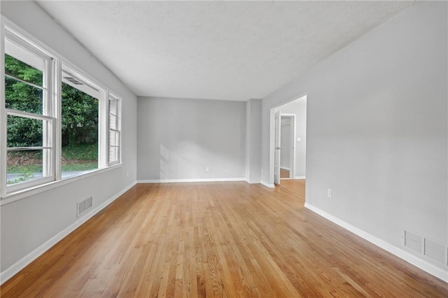 spare room featuring light hardwood / wood-style floors